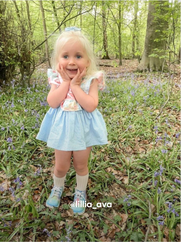 Girl Posing in the Grass - Visit Kickers Kids Instagram